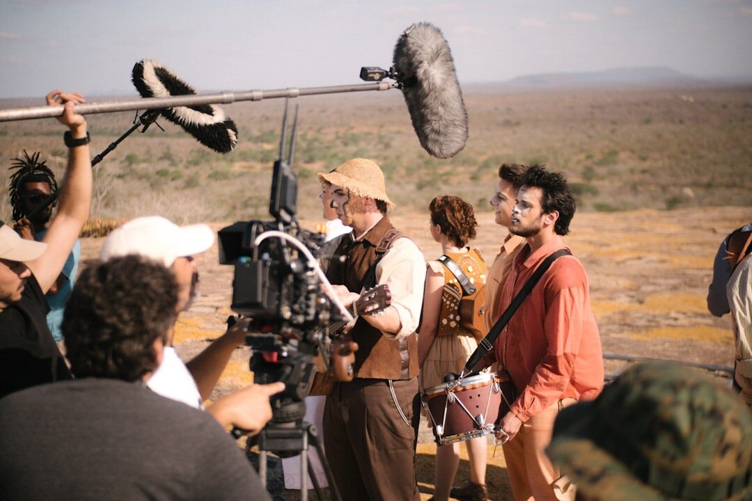 Film crew filming a scene with a camera and a boom microphone