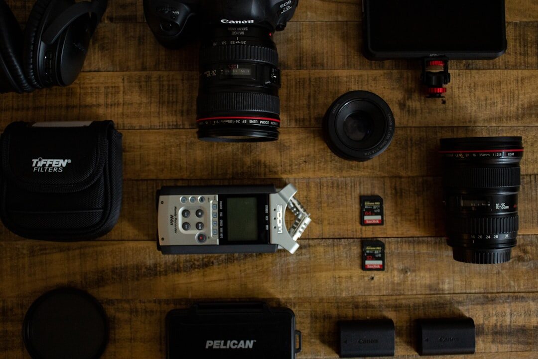 Flat lay of professional camera, lenses and audio recording equipment